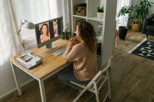Young woman having online video meeting at home