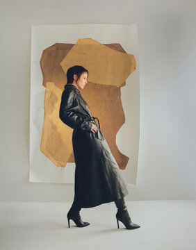 Fashion Top Model In Front Of Abstract Paintings.