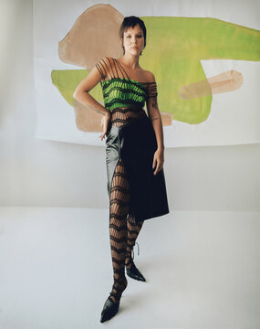 Fashion Top Model In Front Of Abstract Paintings.