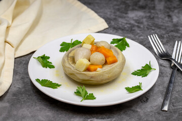 Artichokes with olive oil on a dark background. Traditional delicious Turkish food; (zeytinyagli enginar). Horizontal view. Close up