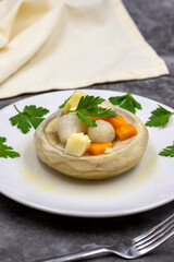 Artichokes with olive oil on a dark background. Traditional delicious Turkish food; (zeytinyagli enginar). Vertical view. Close up