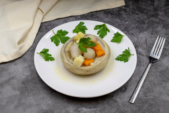 Artichokes with olive oil on a dark background. Traditional delicious Turkish food; (zeytinyagli enginar). Horizontal view. Close up