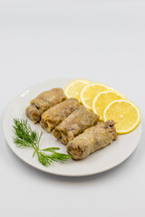 Stuffed cabbage leaves, in a ceramic plate. Vegan cabbage rolls, cooked cabbage leaves, wrapped around a filling of rice, onions and spices. (Lahana sarması) Vertical view. Close up