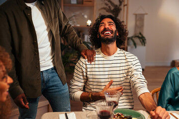 Man laughing during holiday dinner