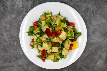Artichoke salad with olive oil on dark background. Traditional delicious Turkish food; (zeytinyagli enginar). Top view. Close up