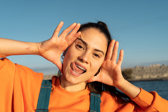 Portrait of cute fun young woman making funny faces