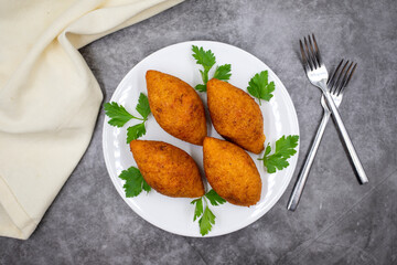 Kibbeh on a dark background. Kibbeh is a popular dish in Middle Eastern cuisine. Stuffed Meatballs Food, Falafel, icli Kofta, Quibe. Top view. Close up