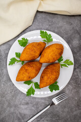 Kibbeh on a dark background. Kibbeh is a popular dish in Middle Eastern cuisine. Stuffed Meatballs Food, Falafel, icli Kofta, Quibe. Top view. Close up