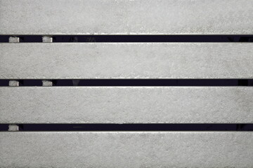 Fototapeta premium Winter and snow. Wooden boards and trunks covered with snow and ice as a base and background. Close-up. 