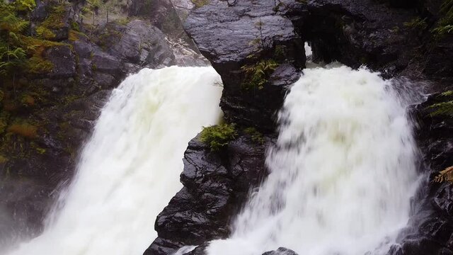 Double sided waterfall filmed in the spring with downward camera movement