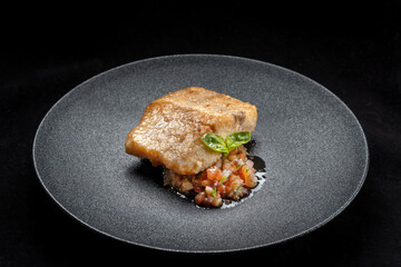 Delicious fish fry served on a beautiful plate, laid out on tartare.
