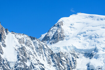 Naklejka premium The snowy Col du Midi in the Mont Blanc massif in Europe, France, the Alps, towards Chamonix, in summer, on a sunny day.