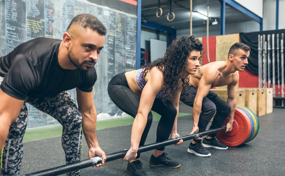 Mixed team lifting weights in the gym