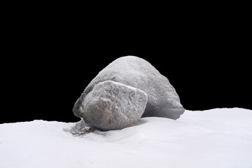 natural stone in snow isolated on black background