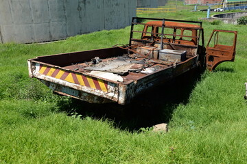 Rusted vehicular wreck abandoned in a wastewater treatment facility