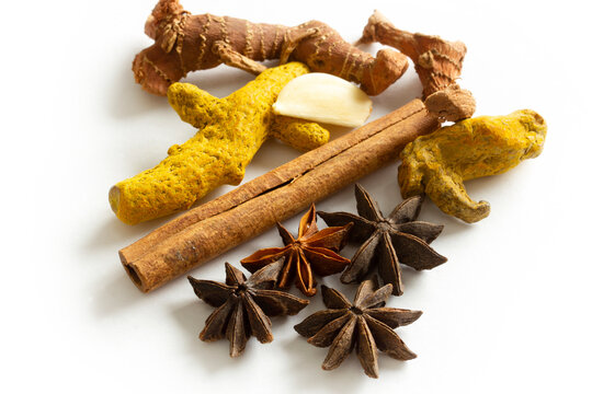 Healthy spices on a white background. Turmeric, ginger, garlic, star anise, cinnamon sticks..