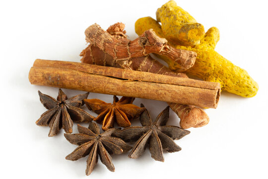 Healthy spices on a white background. Turmeric, ginger, star anise, cinnamon sticks..