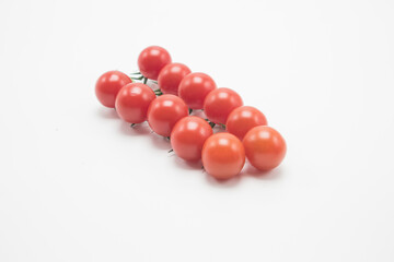 Small tomatoes on a white background.tomato cherry on branch isolated on white background