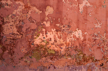 Wall of an old ruined church with a lot of texture and red tones to be used as a background or template.