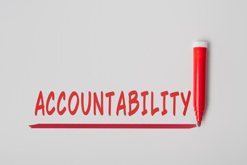 The word 'Accountability', written with red marker over red line, isolated on gray background