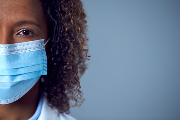 Fototapeta Close Up Studio Portrait Of Female Doctor In PPE With Face Mask Looking At Camera obraz
