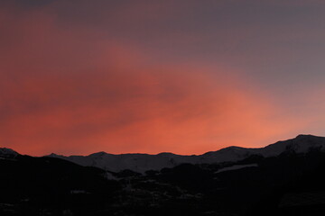 Italian alps at sunset. Gorgeous orange, pink and purple sunset over silhouetted mountains. background. (Aosta, Italy)