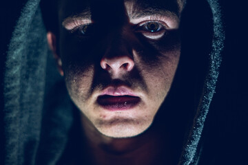 A man with a jacket hat at night, scary