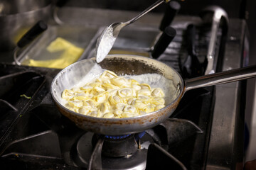 Traditional Italian Tortellini pasta being cooked in a pan