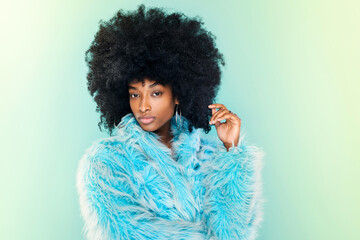 Cute young Black woman wearing a cool blue winter top - obrazy, fototapety, plakaty