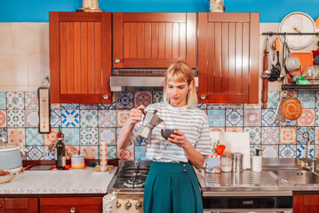 Attractive woman pouring percolated coffee in a kitchen