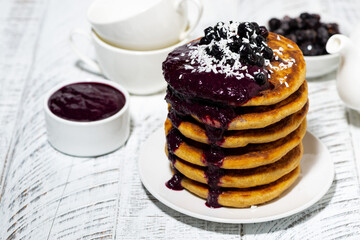 stack of corn pancakes with blueberry jam for breakfast