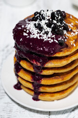 stack of corn pancakes with blueberry jam, vertical closeup