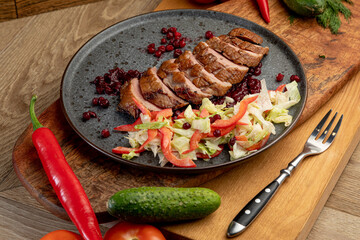 smoked meat with fresh vegetables and currant sauce