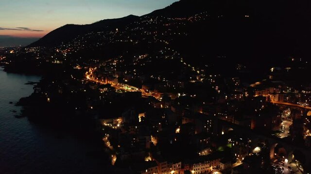 Italy at night. City lights aerial view. Close to Genoa.