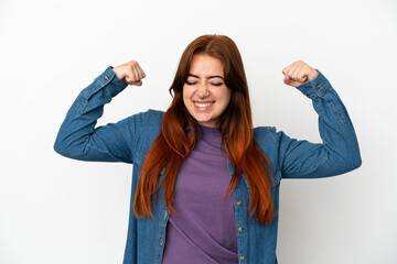 Young redhead woman isolated on white background doing strong gesture