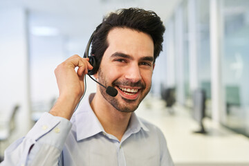 Young businessman as a customer advisor with headset