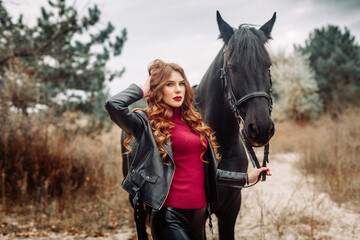Obraz premium Beautiful young woman posing with a horse outdoors, close up