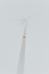 Windturbine in fog from low angle