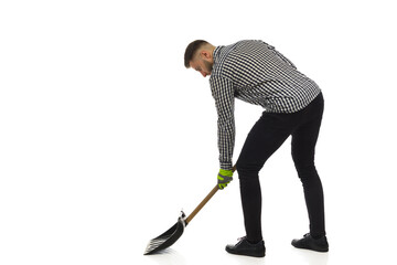 Young man is working with snowshovel. Side view. Full length, isolated. - 478988736