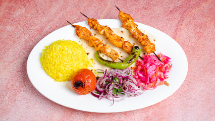Chicken skewers wirh rice pilaf and vegetables