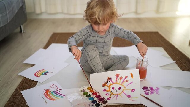 Portrait of little boy of two years old plays with toy tiger on the bed in cozy room Symbol of the year