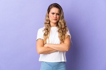 Young Brazilian woman isolated on purple background with unhappy expression