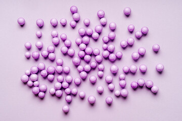 Top view of purple beads on flat surface. Very pery color of the year 2022. Creative make up concept