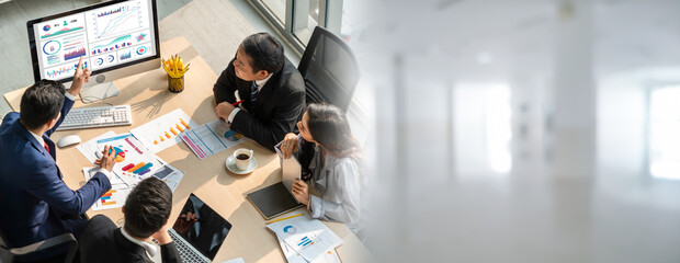 Smart businessman and businesswoman talking discussion in widen group meeting at office table in a modern office interior. Business collaboration strategic planning and brainstorming of coworkers.