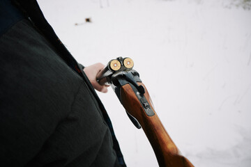 Retro shotgun 16 gauge on a background of snow