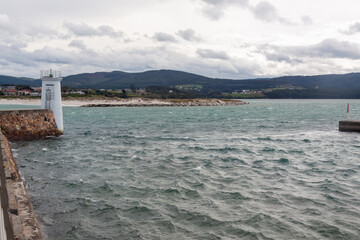 The quay wall and the port lighthouse of the northern Spanish city of Foz in Galicia.