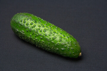 Green fresh cucumber on a black table