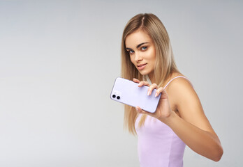 Beautiful woman showing mobile phone. Innovation telephony concept