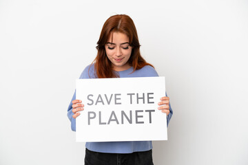 Young redhead woman isolated on white background holding a placard with text Save the Planet