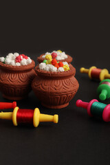 Indian festival makar sankranti concept : Tilgul in small bowl. Tilgul is a colourful sesame candy coated with sesame seeds; in Maharashtra people exchange tilgul on Sankranti